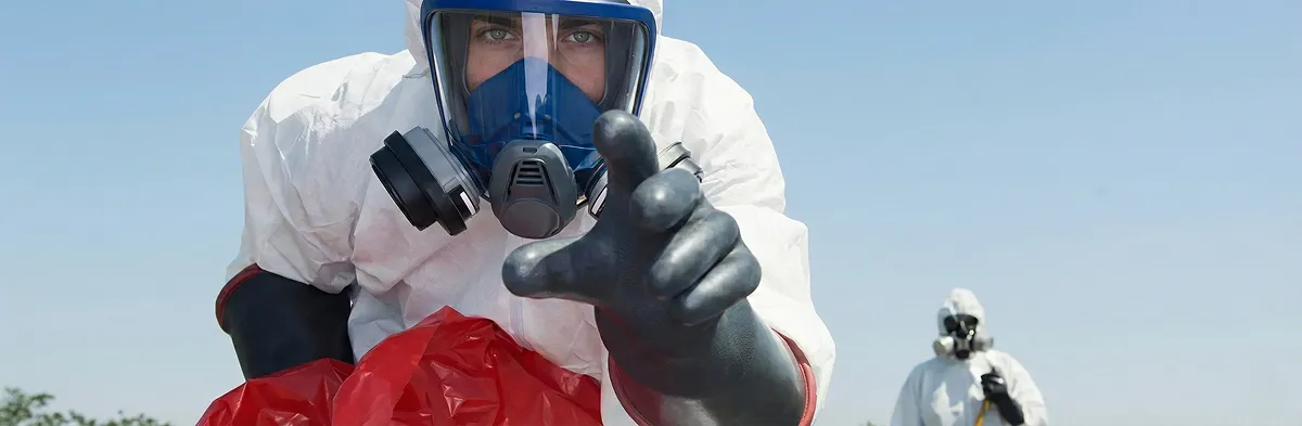 sewage clean up technician wearing protective gear handling biohazard materials in Scottsdale, AZ